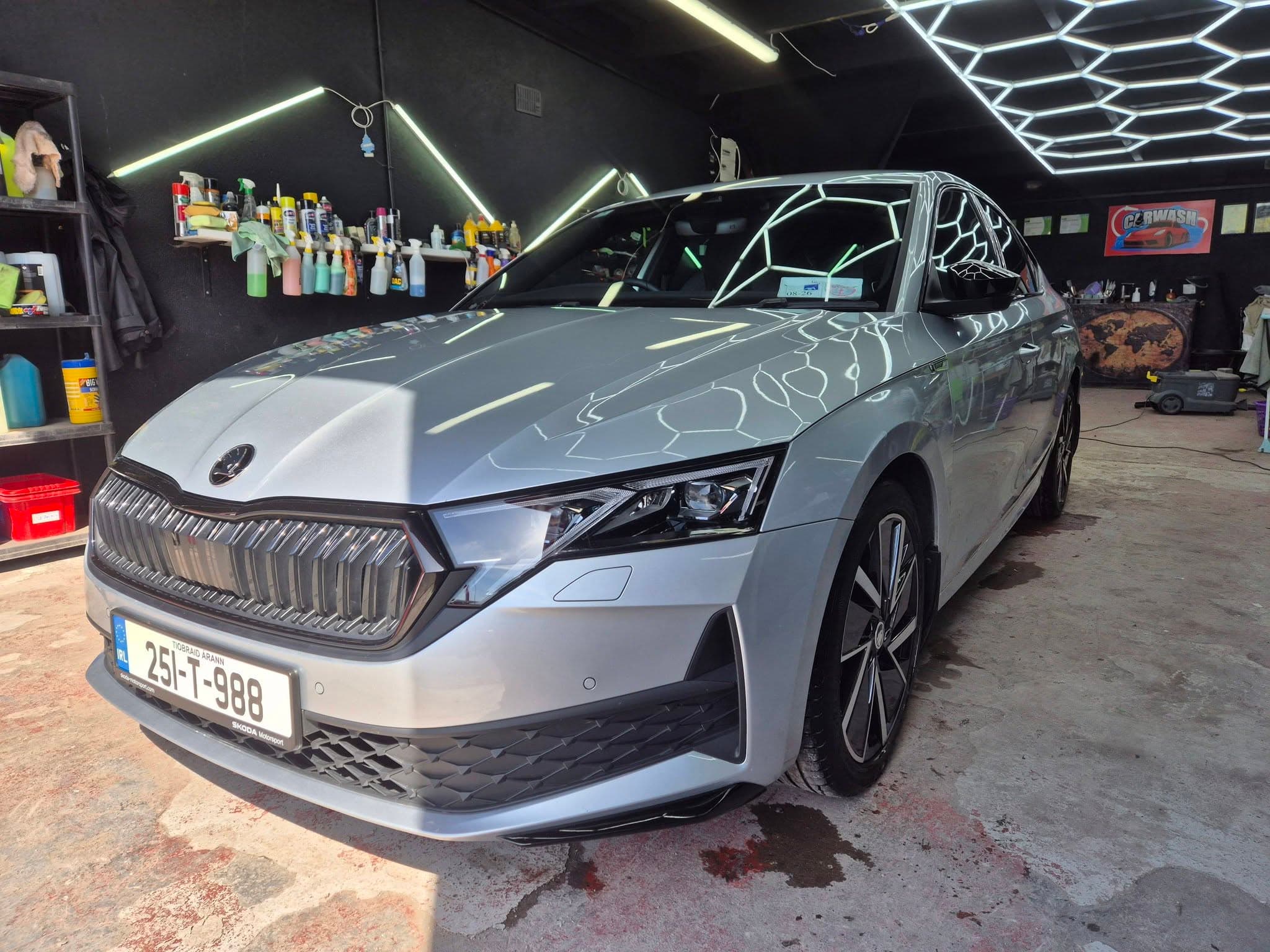 Silver Skoda Octavia inside the studio bay under detailing lights