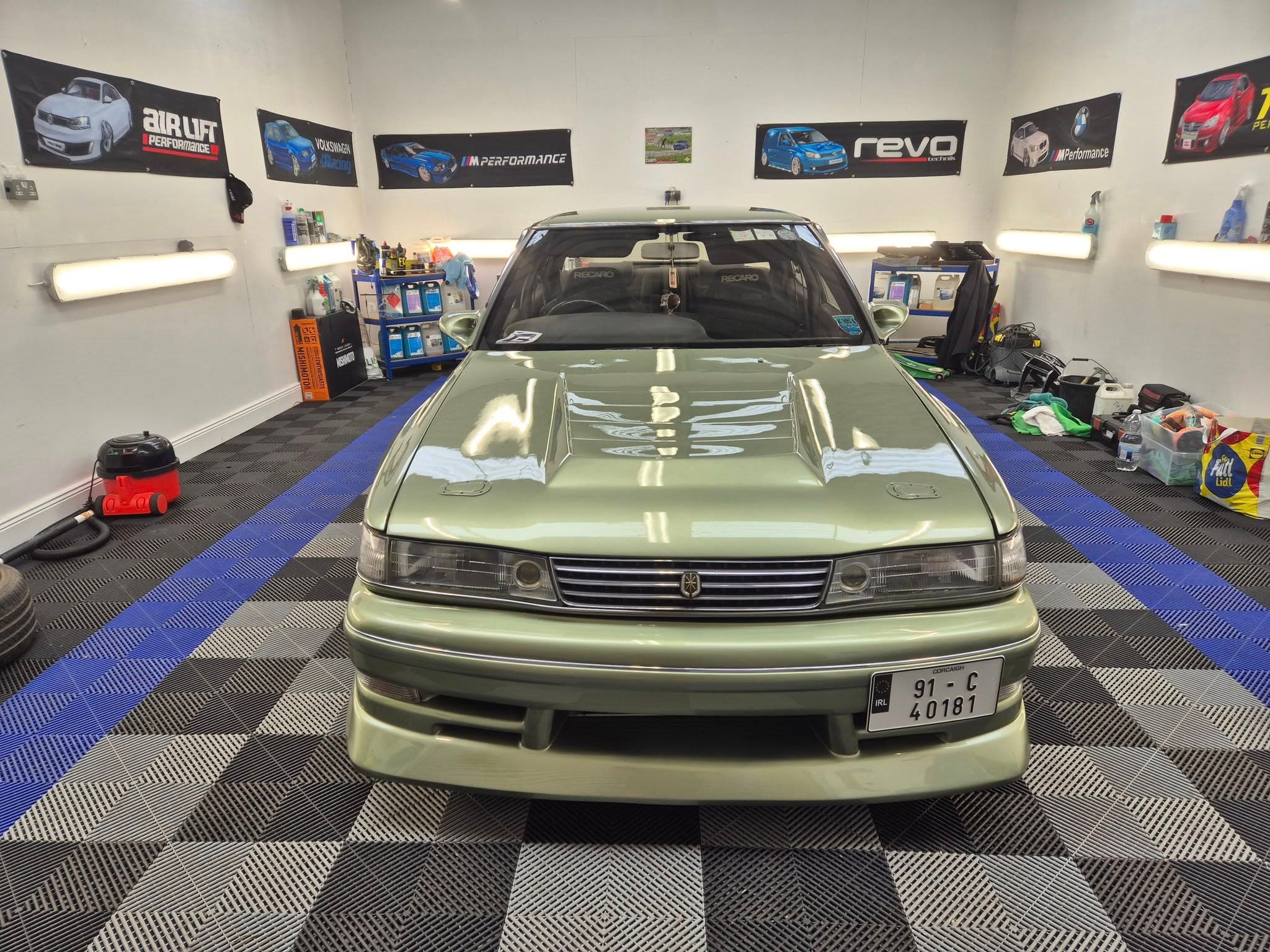 Classic Toyota in studio bay — exterior reset under detailing lighting
