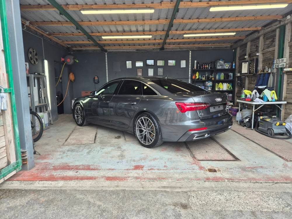 Grey Audi A6 in the studio — post-correction gloss seal